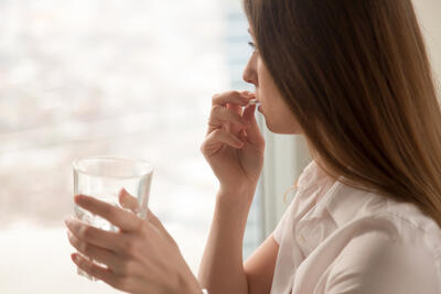 Woman taking a pill